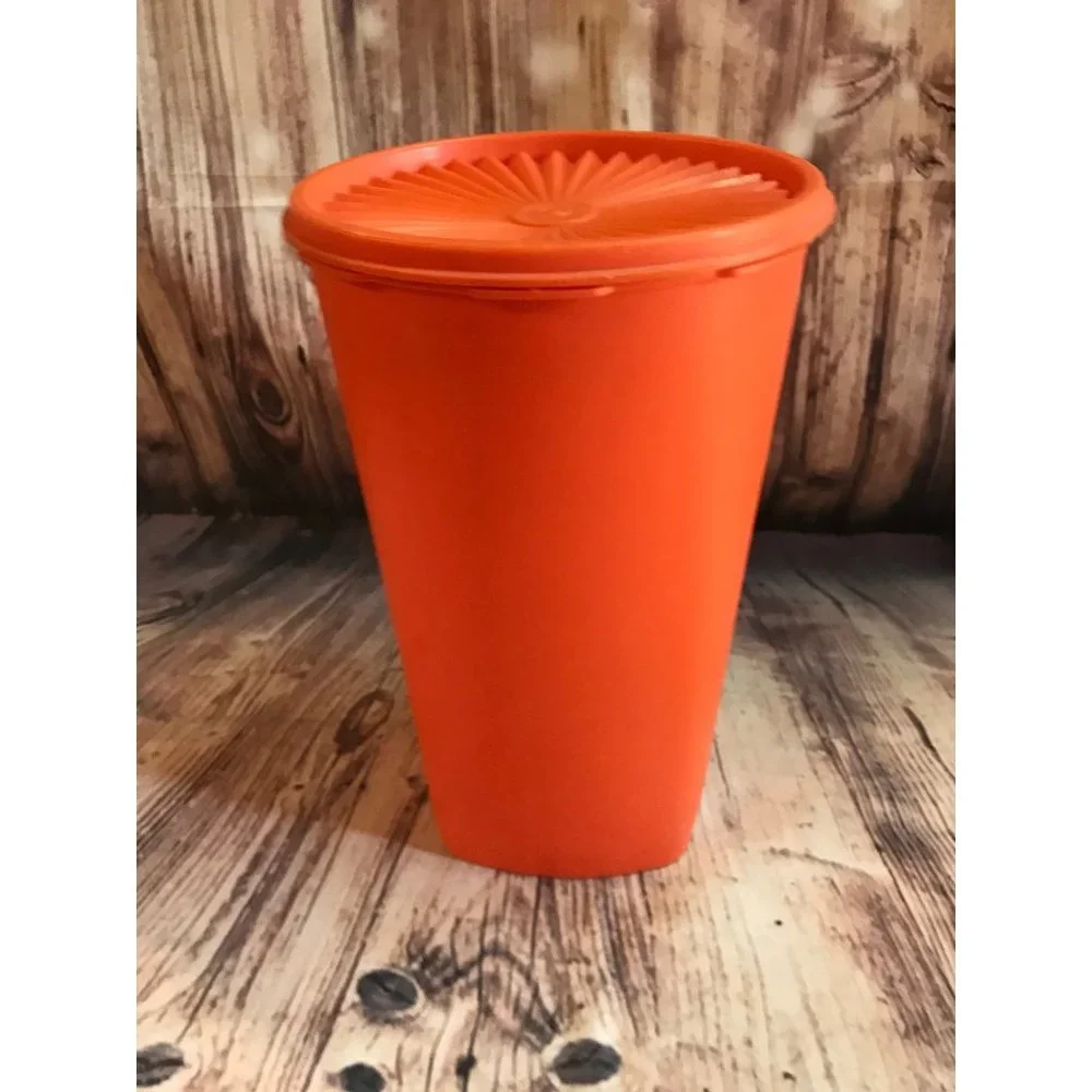 Vintage 70’s tangerine orange Tupperware canister with lid.